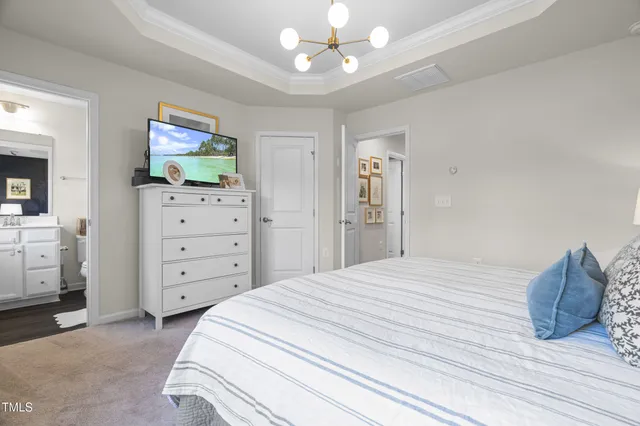 a bedroom with a bed and a mirror