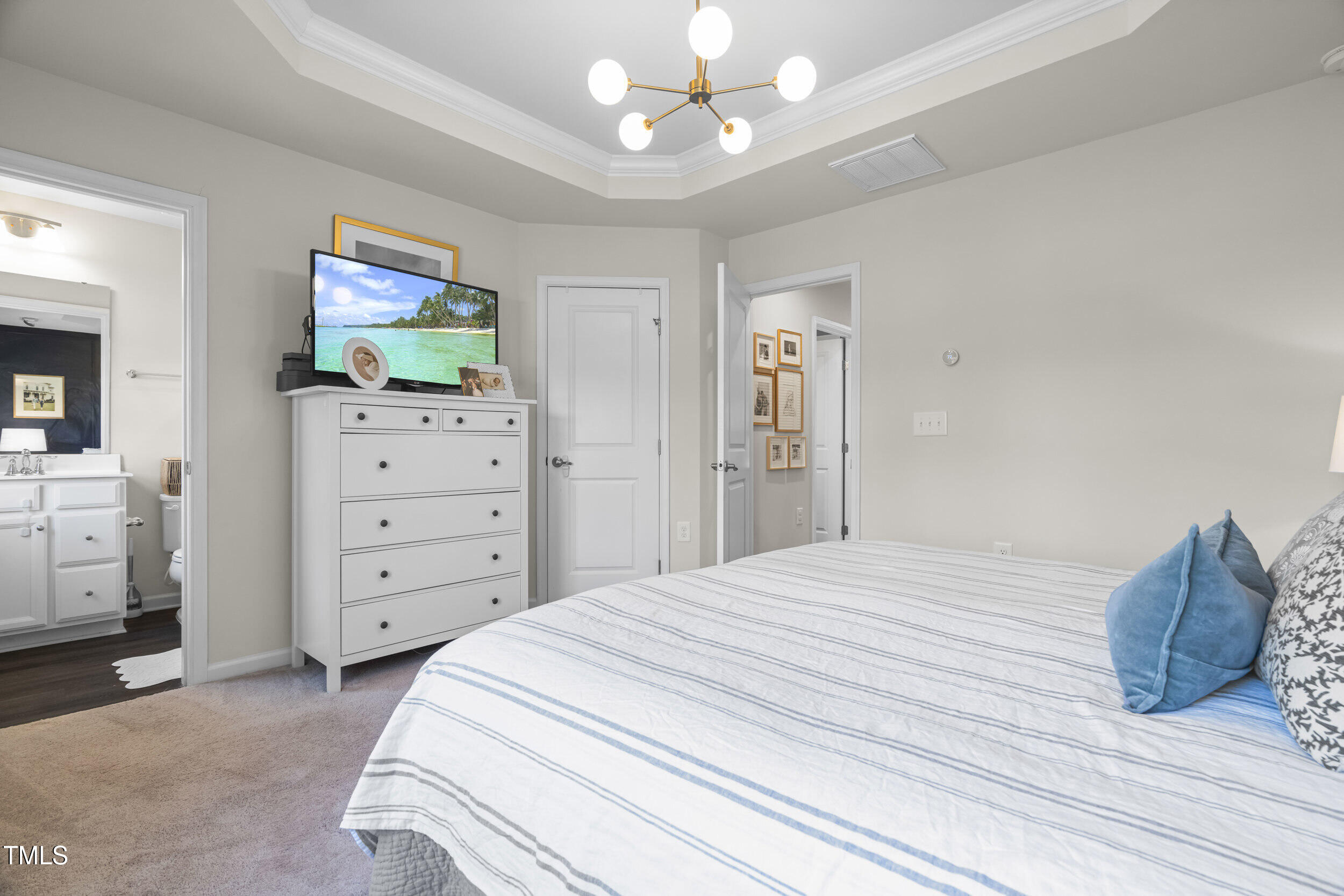 6607 Pathfinder Way Raleigh, NC 27616 - Photo 23 of 37 a bedroom with a bed and a mirror