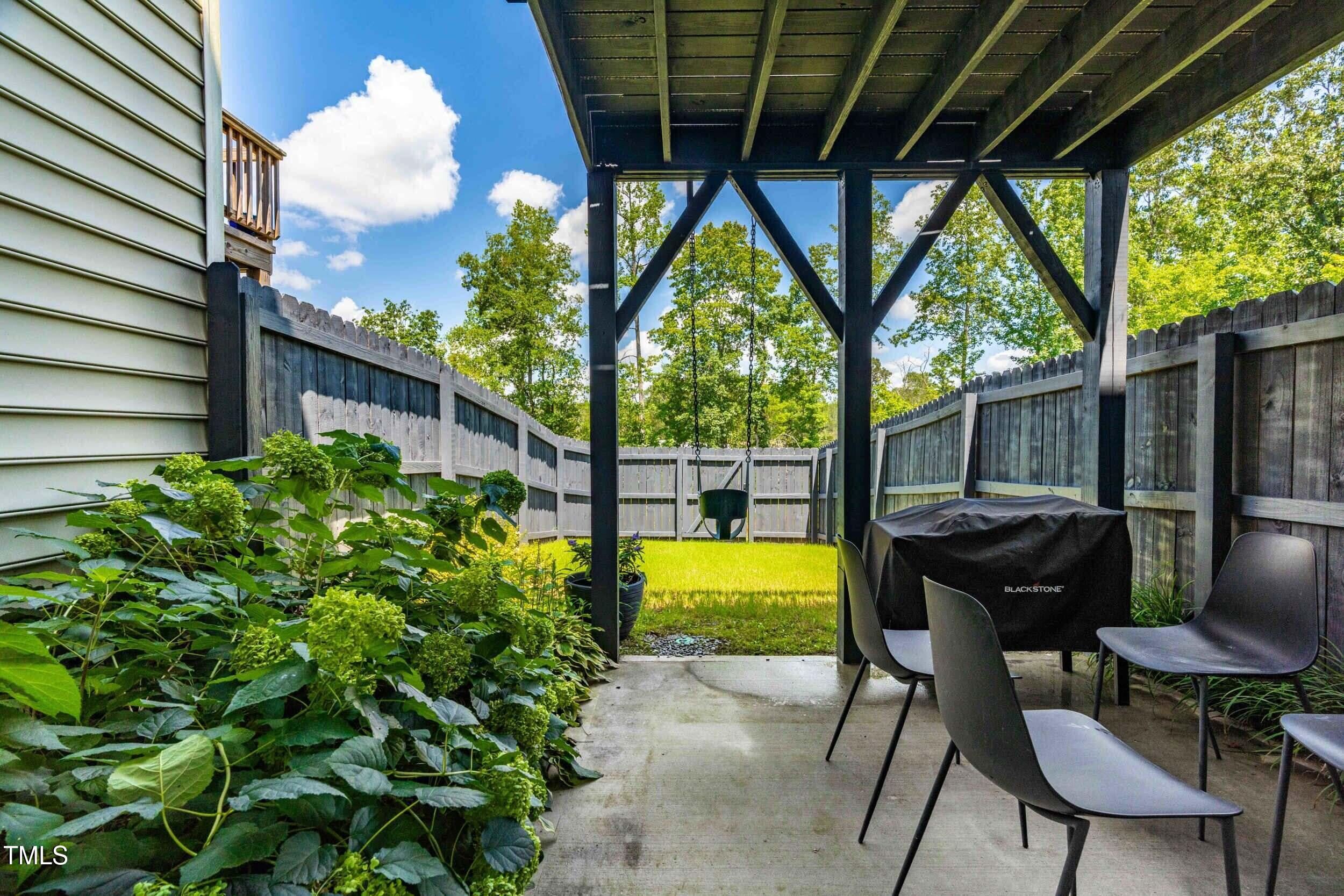 6607 Pathfinder Way Raleigh, NC 27616 - Photo 28 of 37 a view of a chairs and table in the patio next to a yard