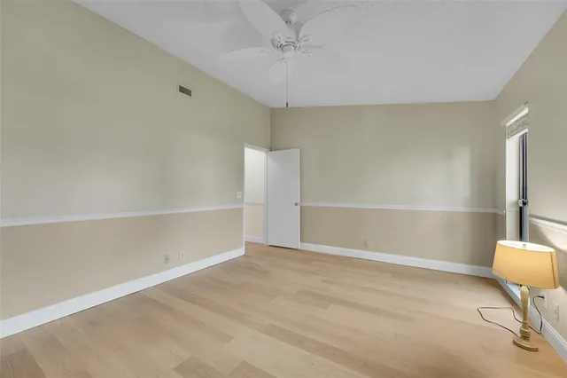a bathroom with a granite countertop sink mirror vanity and toilet