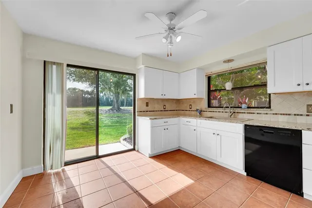 a kitchen with stainless steel appliances granite countertop a refrigerator oven a sink and dishwasher
