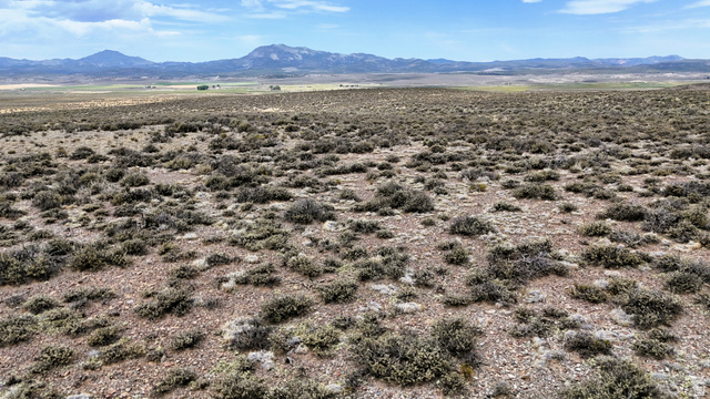 123 East Tbd 5000 Road North Panguitch, UT 84759 - Photo 37 of 54 Expansive open terrain featuring natural vegetation and distant mountain ranges under a partly cloudy sky