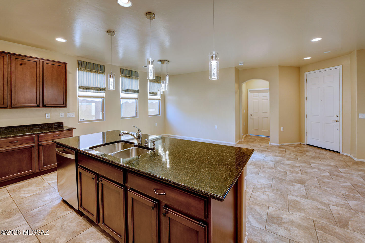 13991 East Cheavront Loop Vail, AZ 85641 - Photo 7 of 47 a kitchen with granite countertop sink stove and cabinets