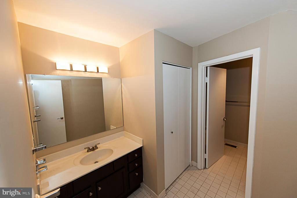 11011 Thrush Ridge Road Reston, VA 20191 - Photo 21 of 30 a bathroom with a sink vanity and mirror