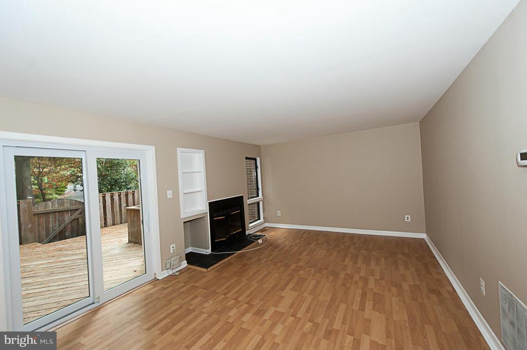 11011 Thrush Ridge Road Reston, VA 20191 - Photo 7 of 30 a view of empty room with wooden floor and fireplace