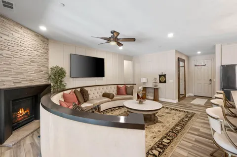 a living room with furniture a flat screen tv and a fireplace