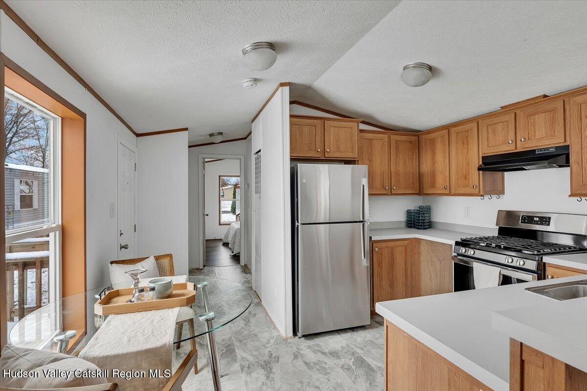 331 Rowland Street, Unit 51 Ballston Spa, NY 12020 - Photo 11 of 18 a kitchen with stainless steel appliances granite countertop a refrigerator stove microwave and sink