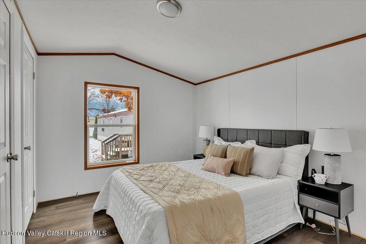 331 Rowland Street, Unit 51 Ballston Spa, NY 12020 - Photo 13 of 18 a bedroom with a bed and painting on the wall