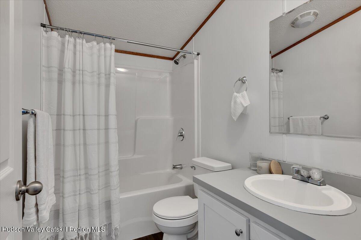 331 Rowland Street, Unit 51 Ballston Spa, NY 12020 - Photo 15 of 18 a bathroom with a sink toilet a mirror and shower