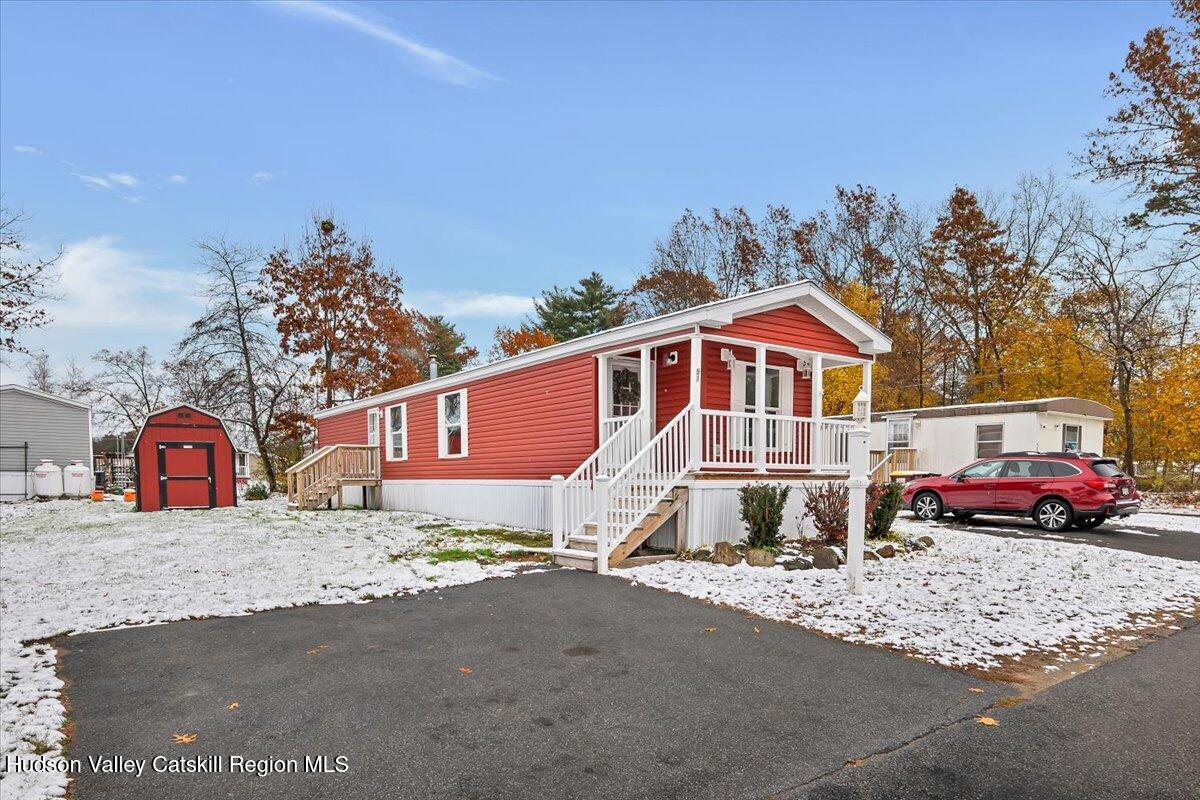 331 Rowland Street, Unit 51 Ballston Spa, NY 12020 - Photo 18 of 18 a front view of a house with a yard and garage