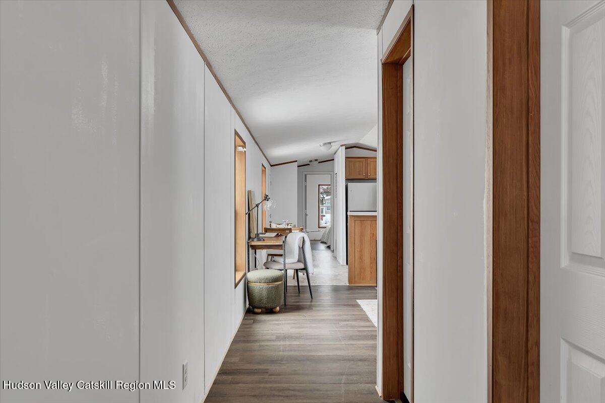 331 Rowland Street, Unit 51 Ballston Spa, NY 12020 - Photo 5 of 18 a view of a hallway with wooden floor and staircase