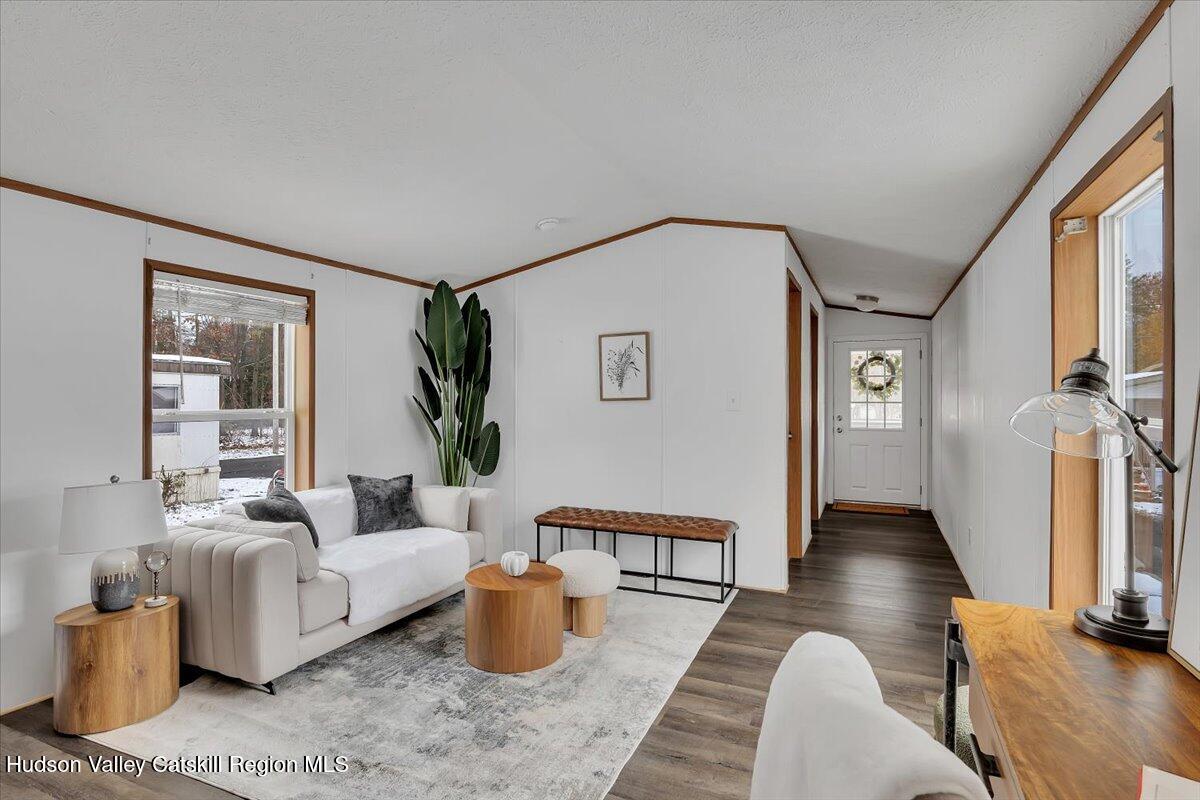 331 Rowland Street, Unit 51 Ballston Spa, NY 12020 - Photo 8 of 18 a living room with furniture a table and wooden floor