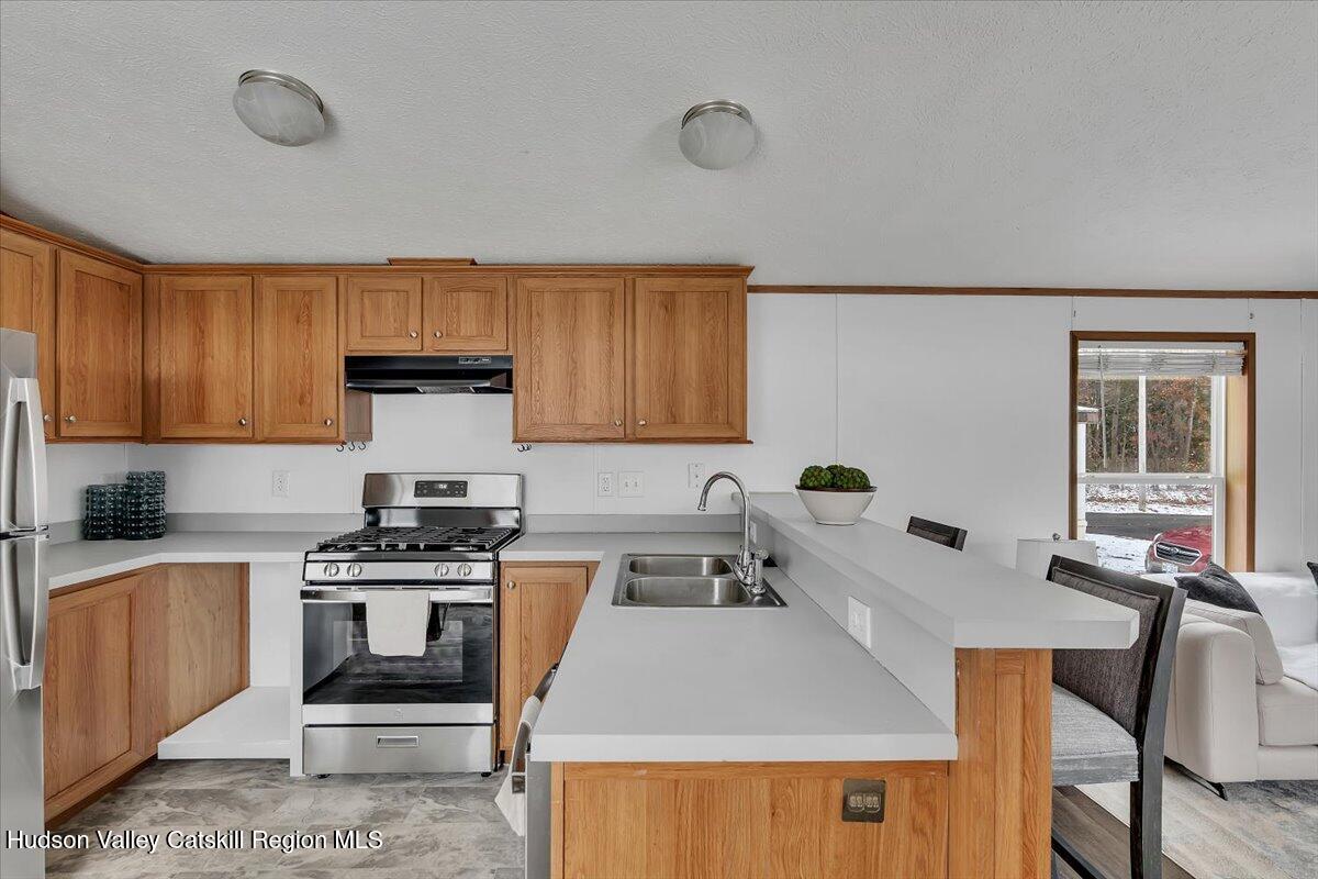 331 Rowland Street, Unit 51 Ballston Spa, NY 12020 - Photo 9 of 18 a kitchen with a table chairs stove and cabinets