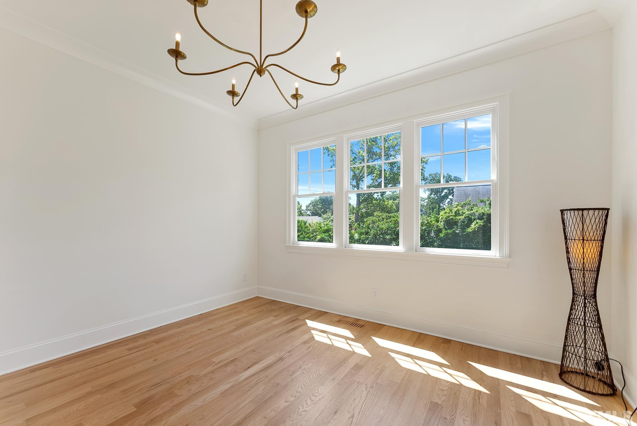 3401 Lewis Farm Road Raleigh, NC 27607 - Photo 29 of 75 a view of empty room with wooden floor and fan