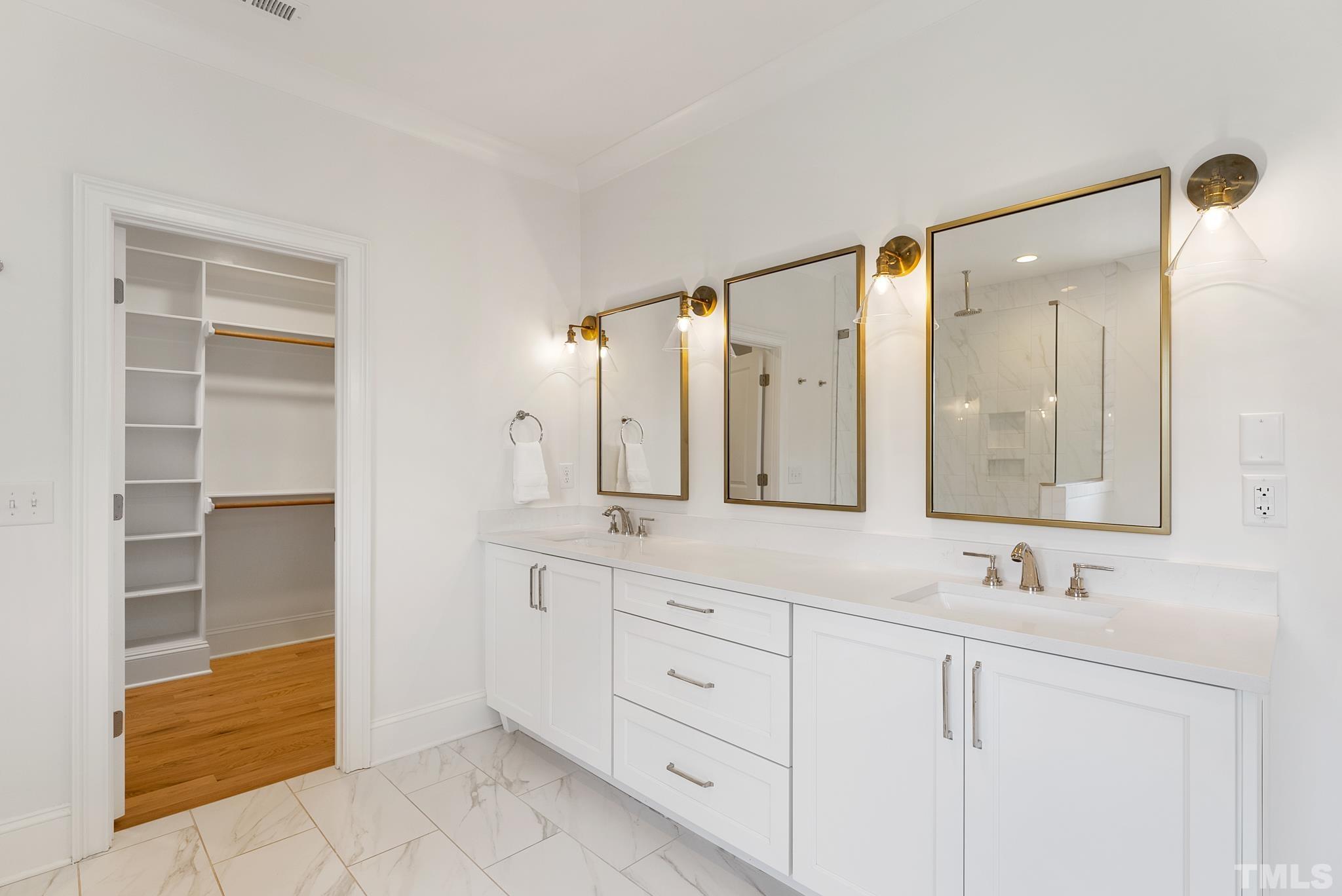 3401 Lewis Farm Road Raleigh, NC 27607 - Photo 40 of 75 a bathroom with a double vanity sink and a mirror