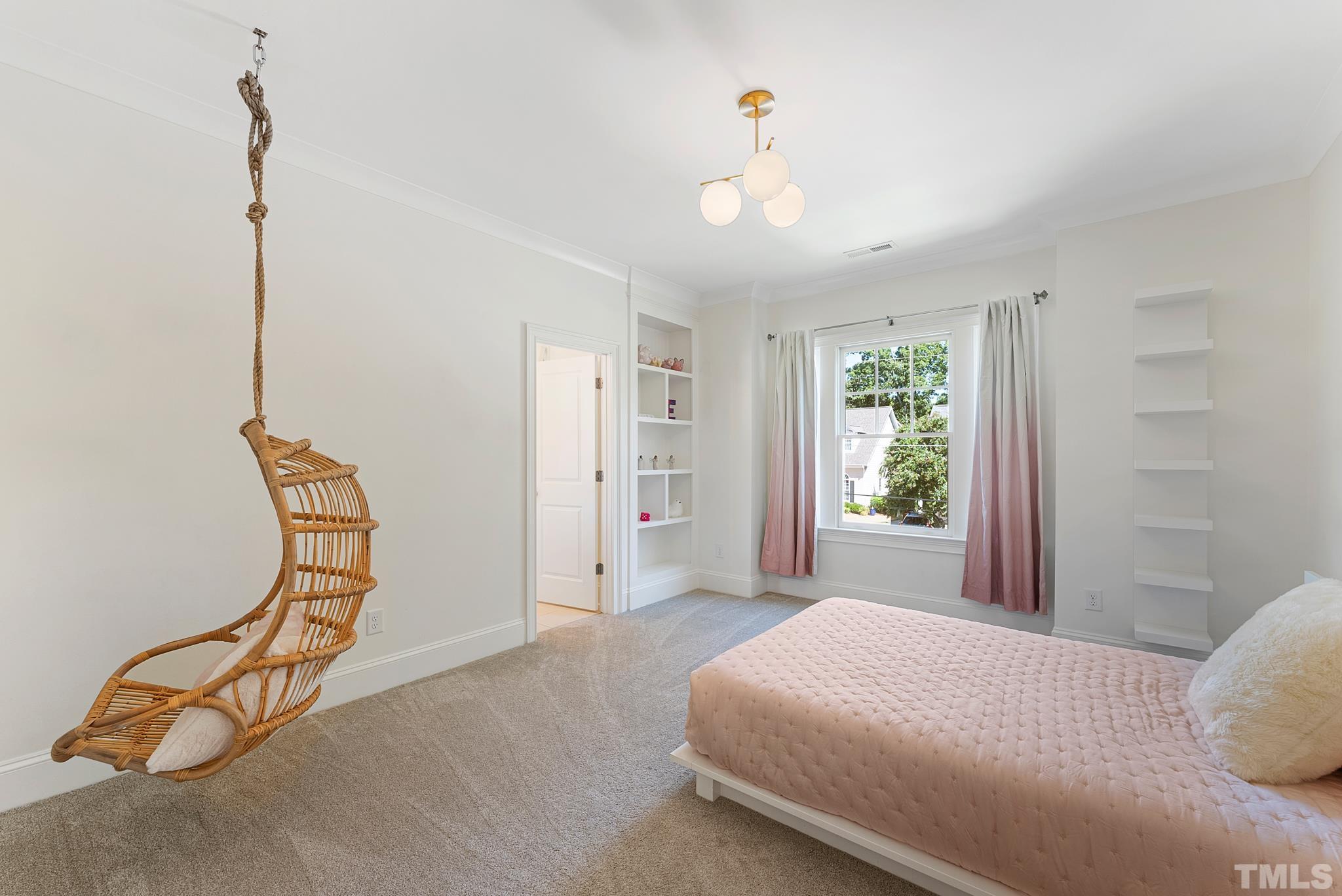 3401 Lewis Farm Road Raleigh, NC 27607 - Photo 45 of 75 a bedroom with a bed and a chandelier