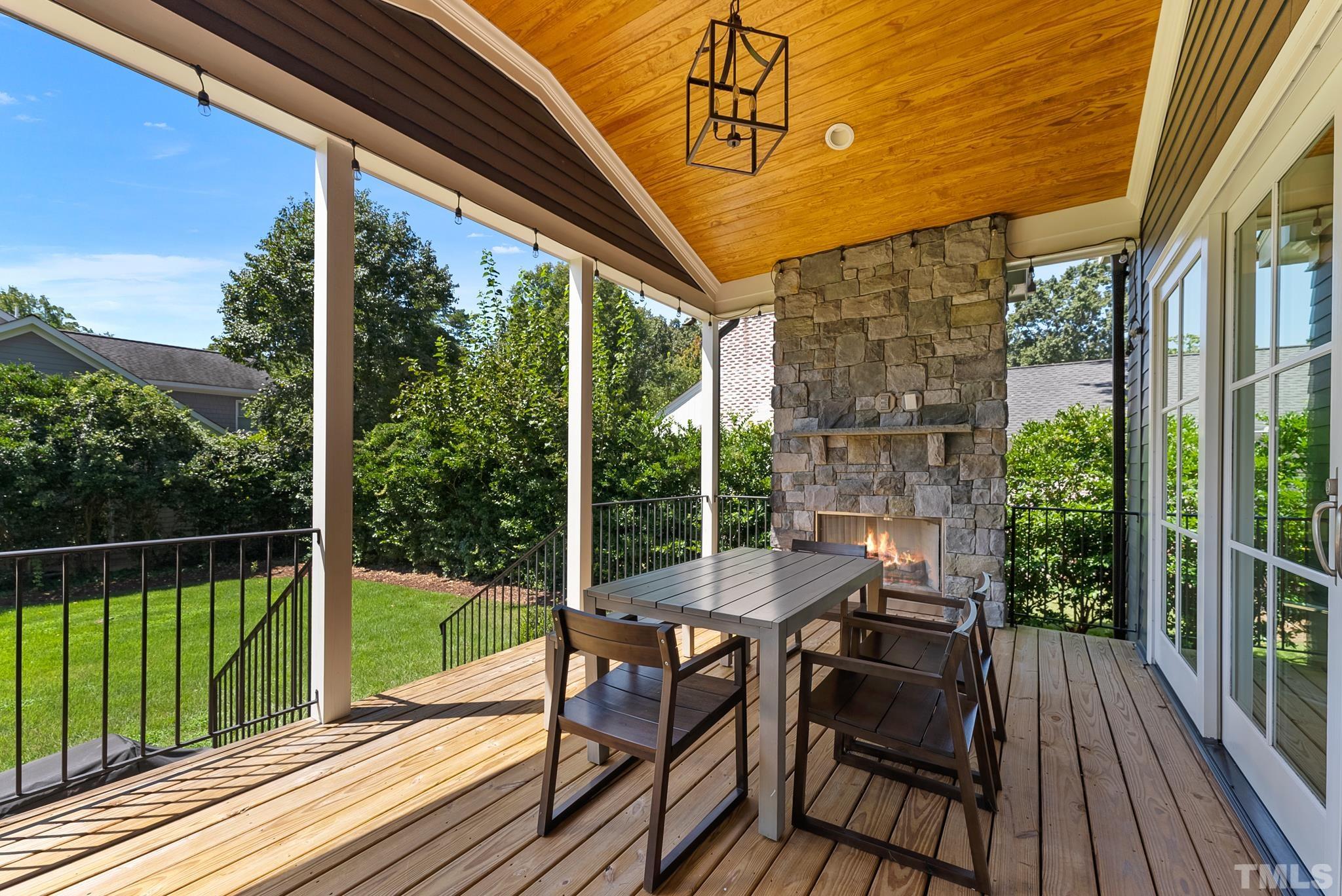 3401 Lewis Farm Road Raleigh, NC 27607 - Photo 62 of 75 a view of a patio with a table chairs and wooden floor