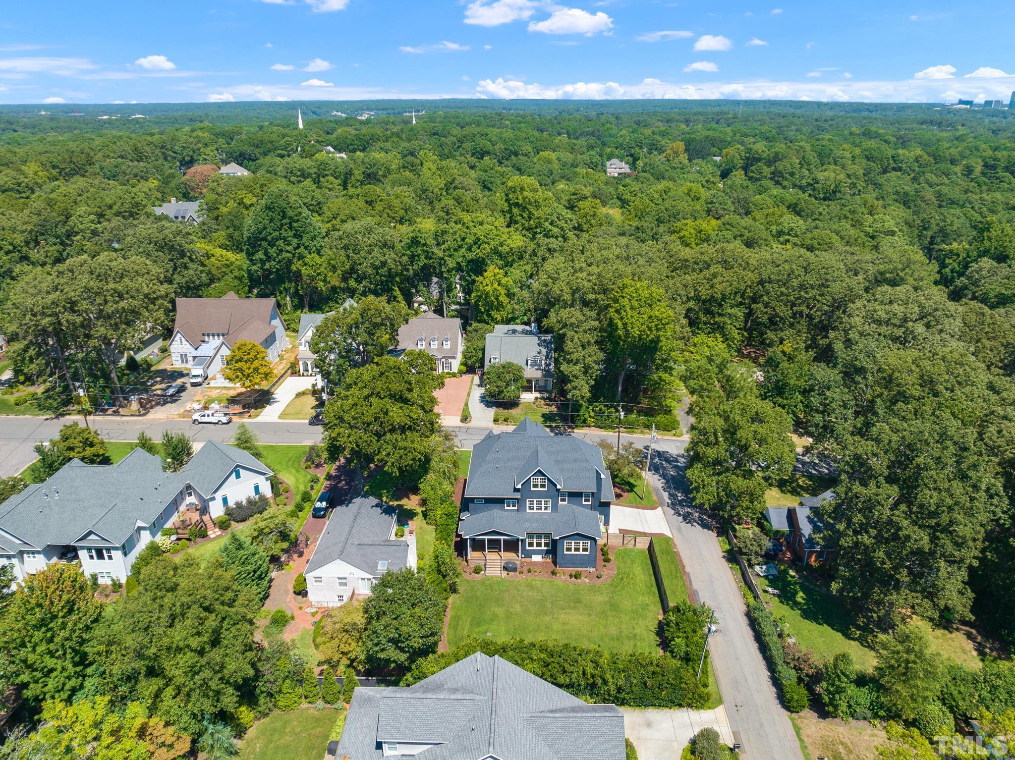 3401 Lewis Farm Road Raleigh, NC 27607 - Photo 72 of 75 an aerial view of a house with a yard and lake view
