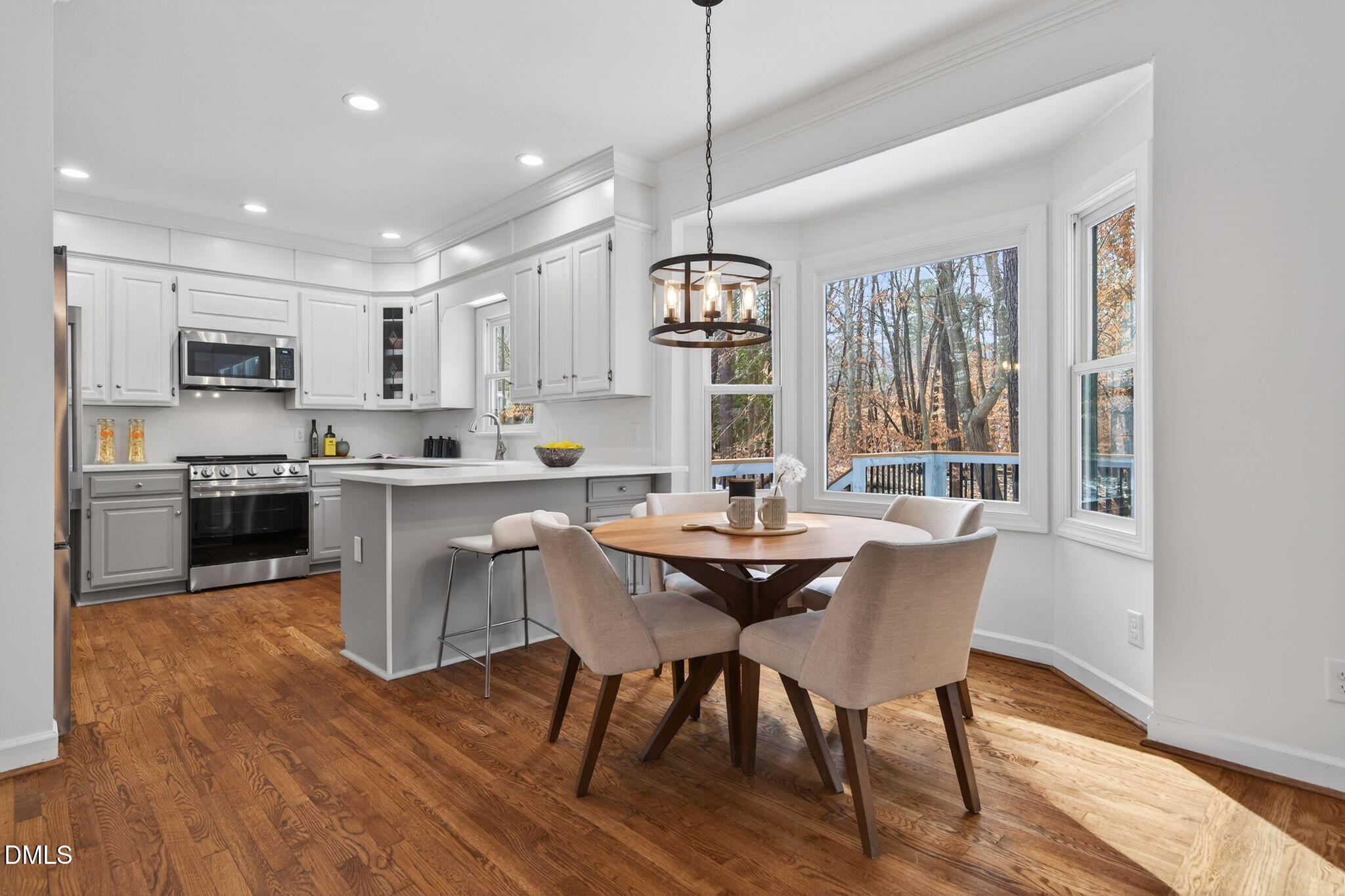 11505 Burberry Drive Raleigh, NC 27614 - Photo 17 of 80 a kitchen with stainless steel appliances granite countertop a stove a sink a microwave refrigerator and chairs