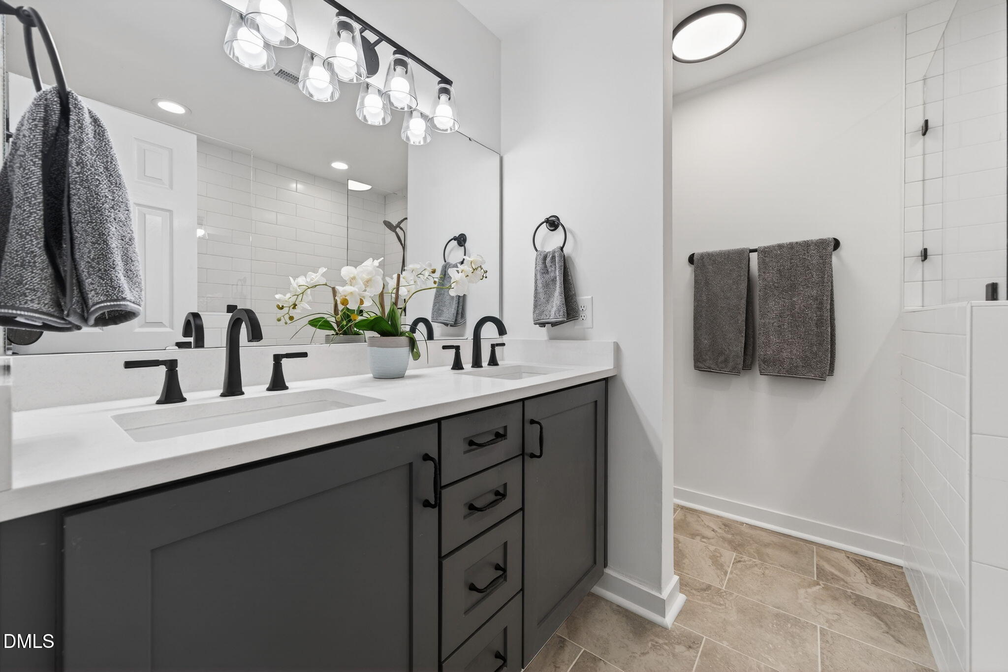 11505 Burberry Drive Raleigh, NC 27614 - Photo 30 of 80 a bathroom with a double vanity sink and a mirror