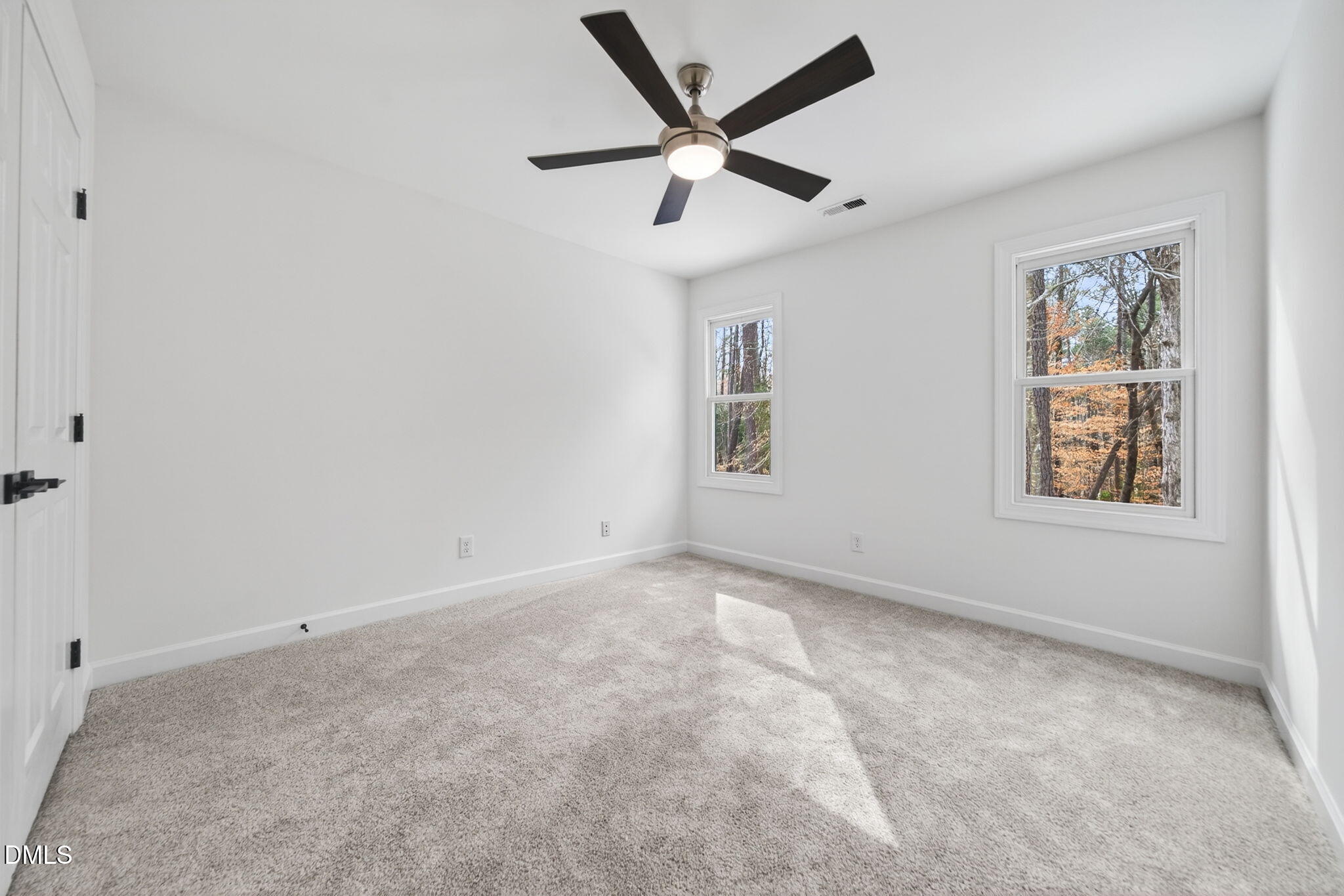 11505 Burberry Drive Raleigh, NC 27614 - Photo 36 of 80 a view of a livingroom with a ceiling fan & windows