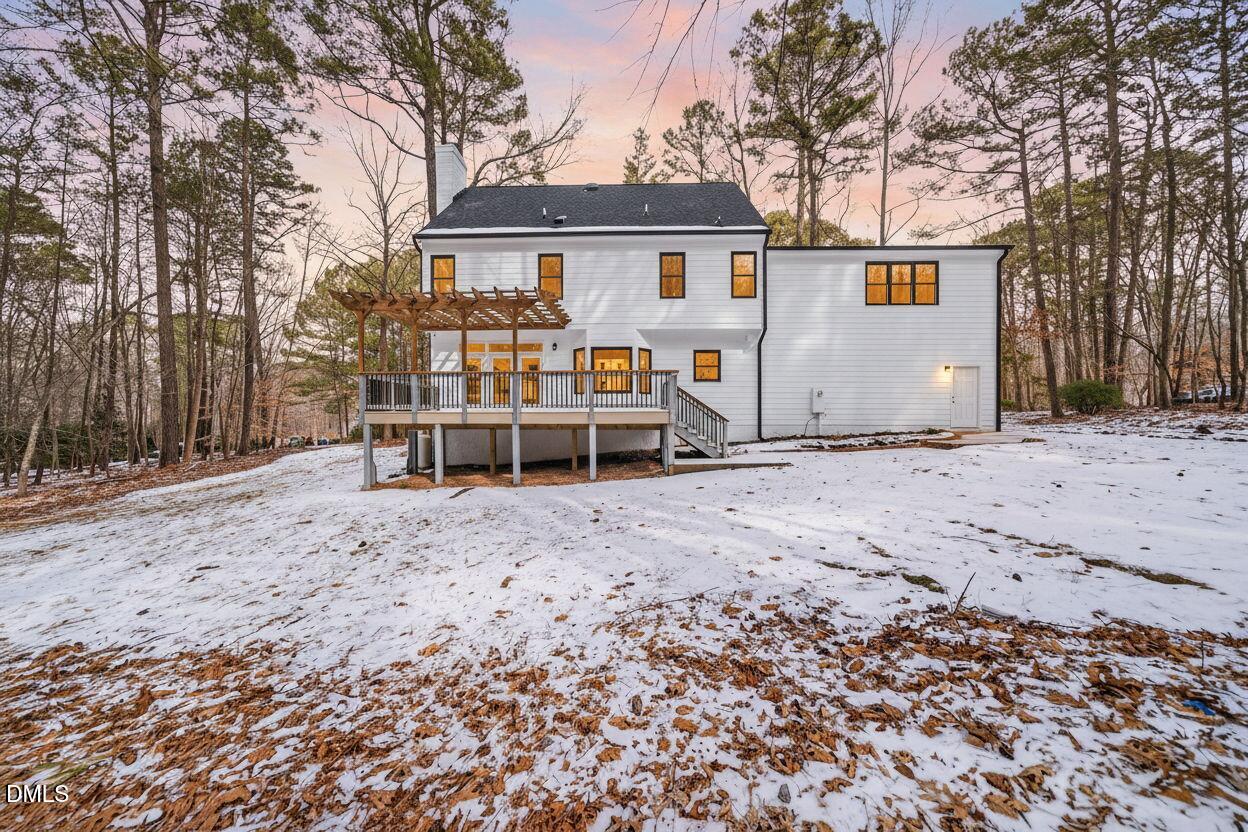 11505 Burberry Drive Raleigh, NC 27614 - Photo 75 of 80 a view of a white house that has a bench and large trees