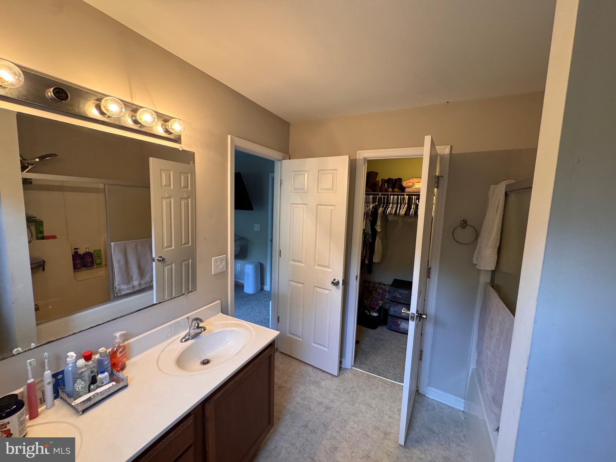 277 McDonald Road Winchester, VA 22602 - Photo 16 of 35 a bathroom with a tub sink a mirror and a shower