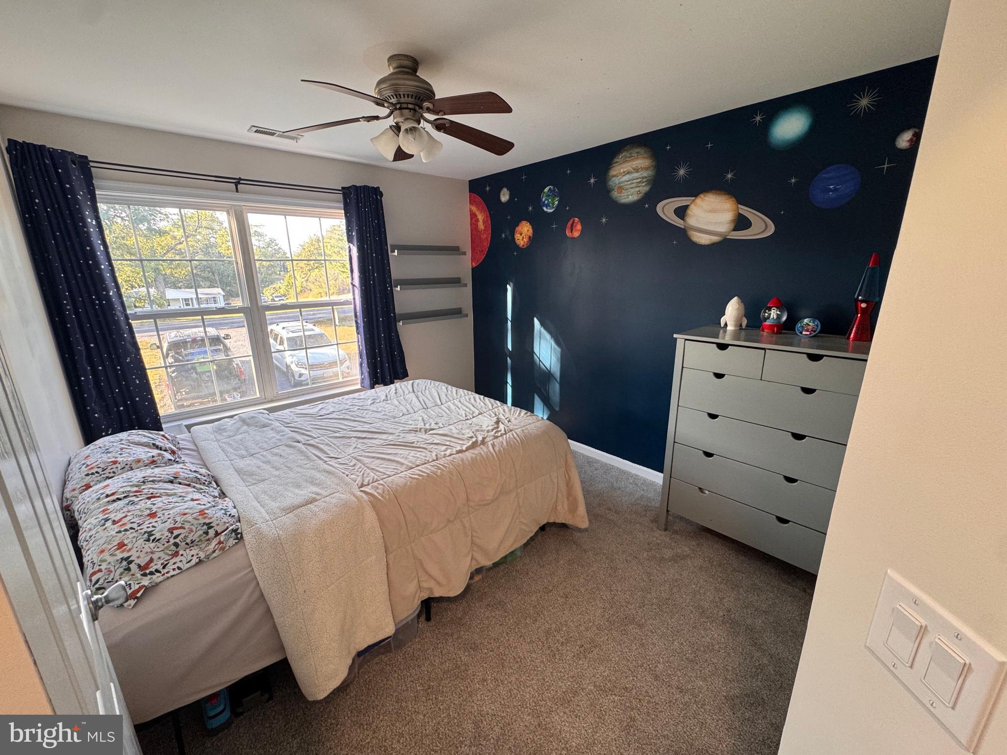 277 McDonald Road Winchester, VA 22602 - Photo 17 of 35 a bedroom with a bed and a flat tv screen on the dresser