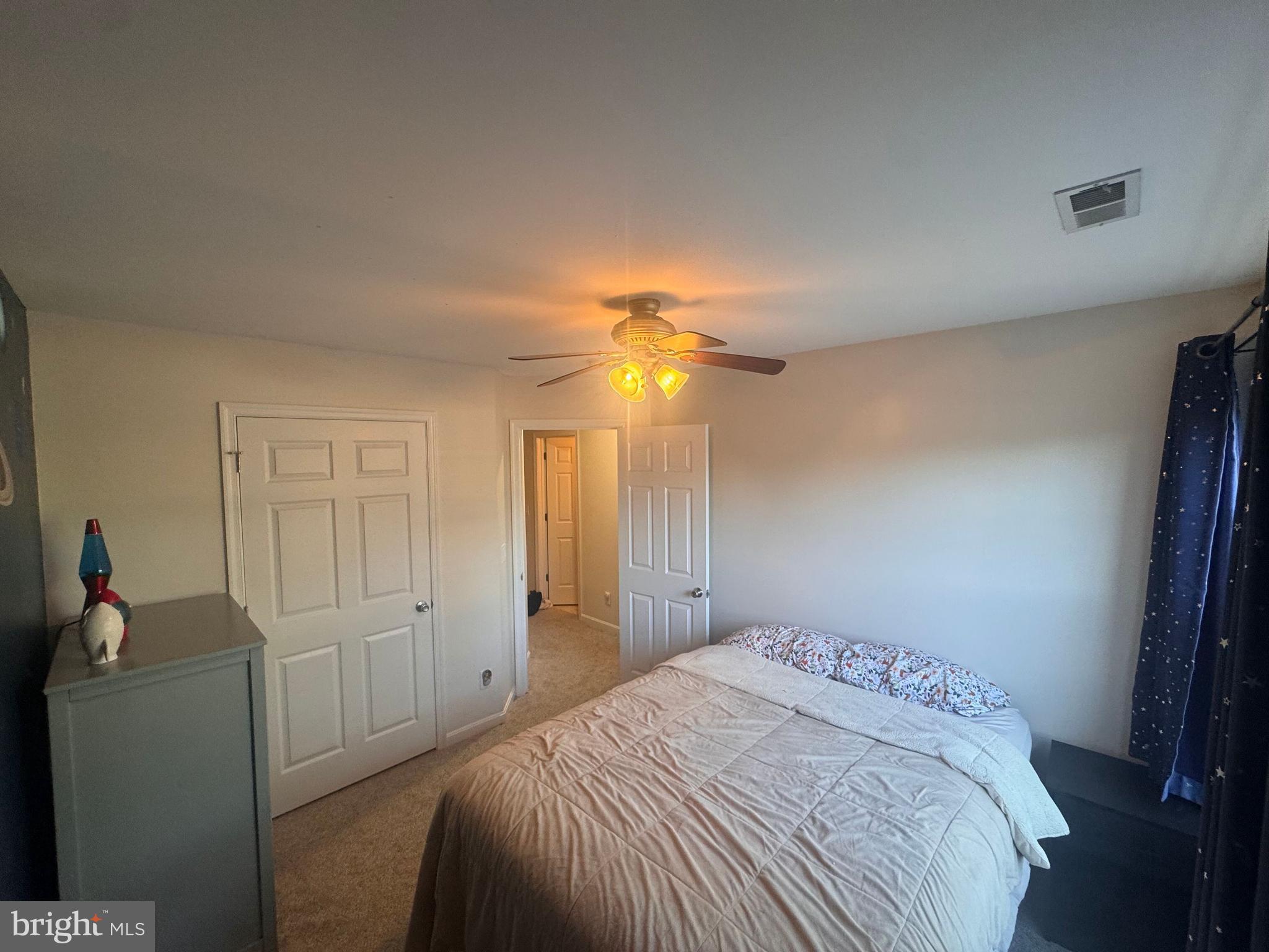 277 McDonald Road Winchester, VA 22602 - Photo 18 of 35 a bedroom with a bed and a chandelier