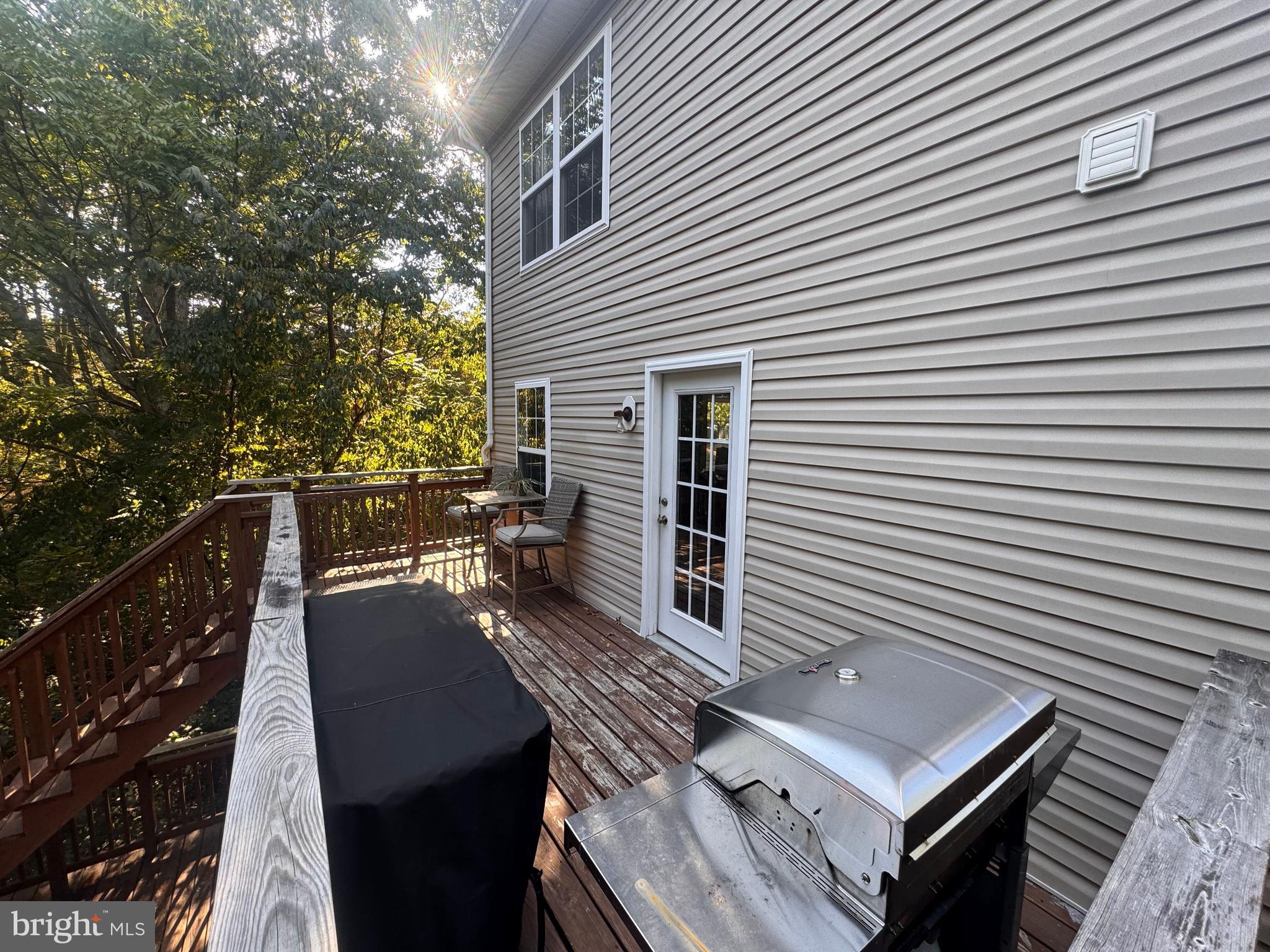 277 McDonald Road Winchester, VA 22602 - Photo 30 of 35 a view of a roof deck with wooden floor and fence with a barbeque