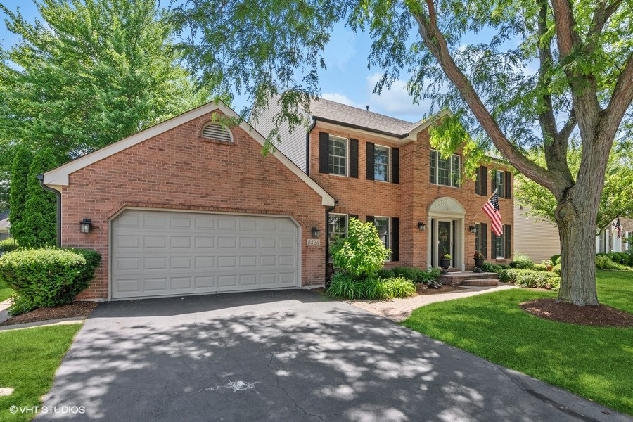 2325 Fairfax Road St. Charles, IL 60174 - Photo 1 of 42 a front view of a house with a garden and trees