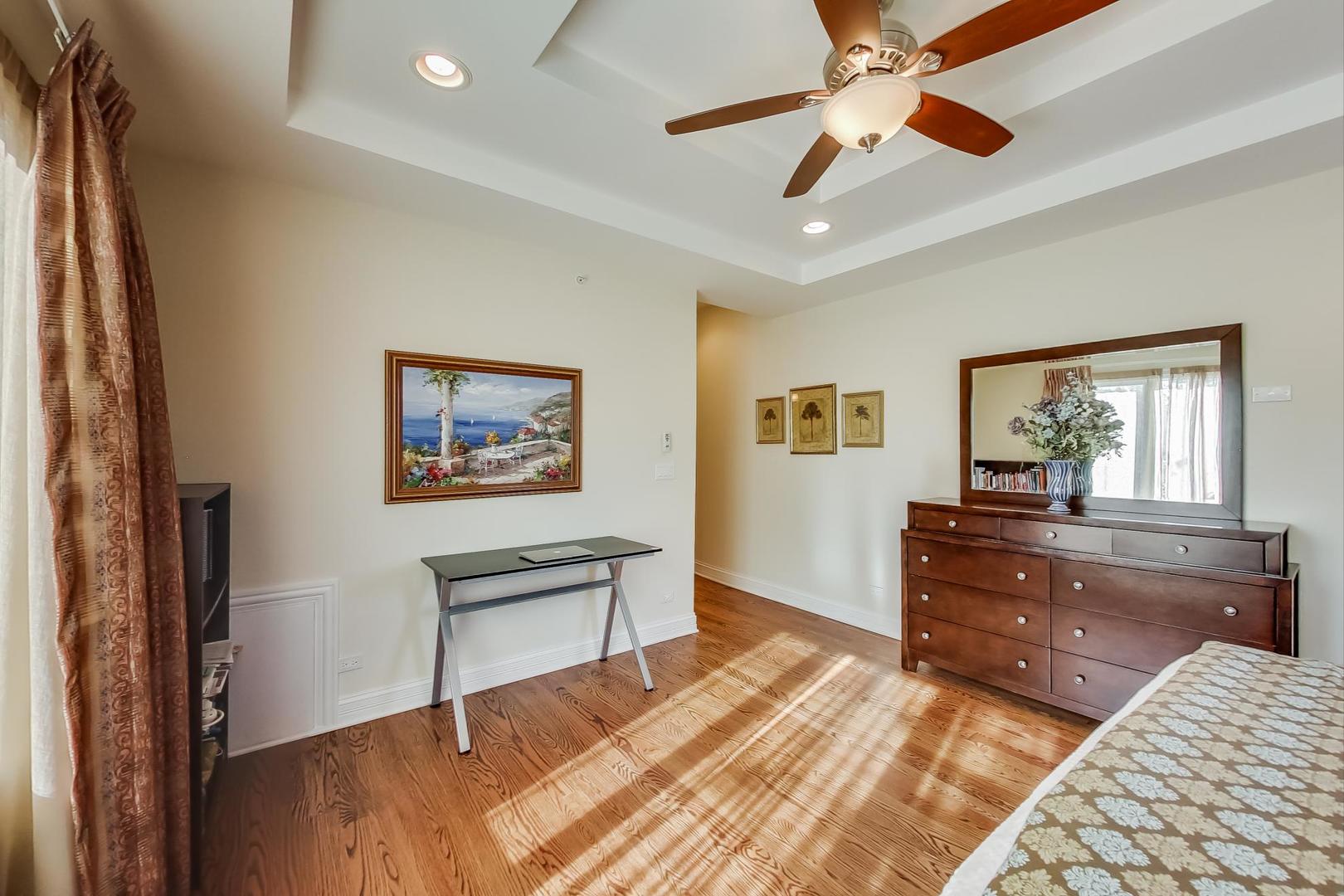 2072 De Cook Avenue Park Ridge, IL 60068 - Photo 22 of 68 a bedroom with a bed and a chandelier