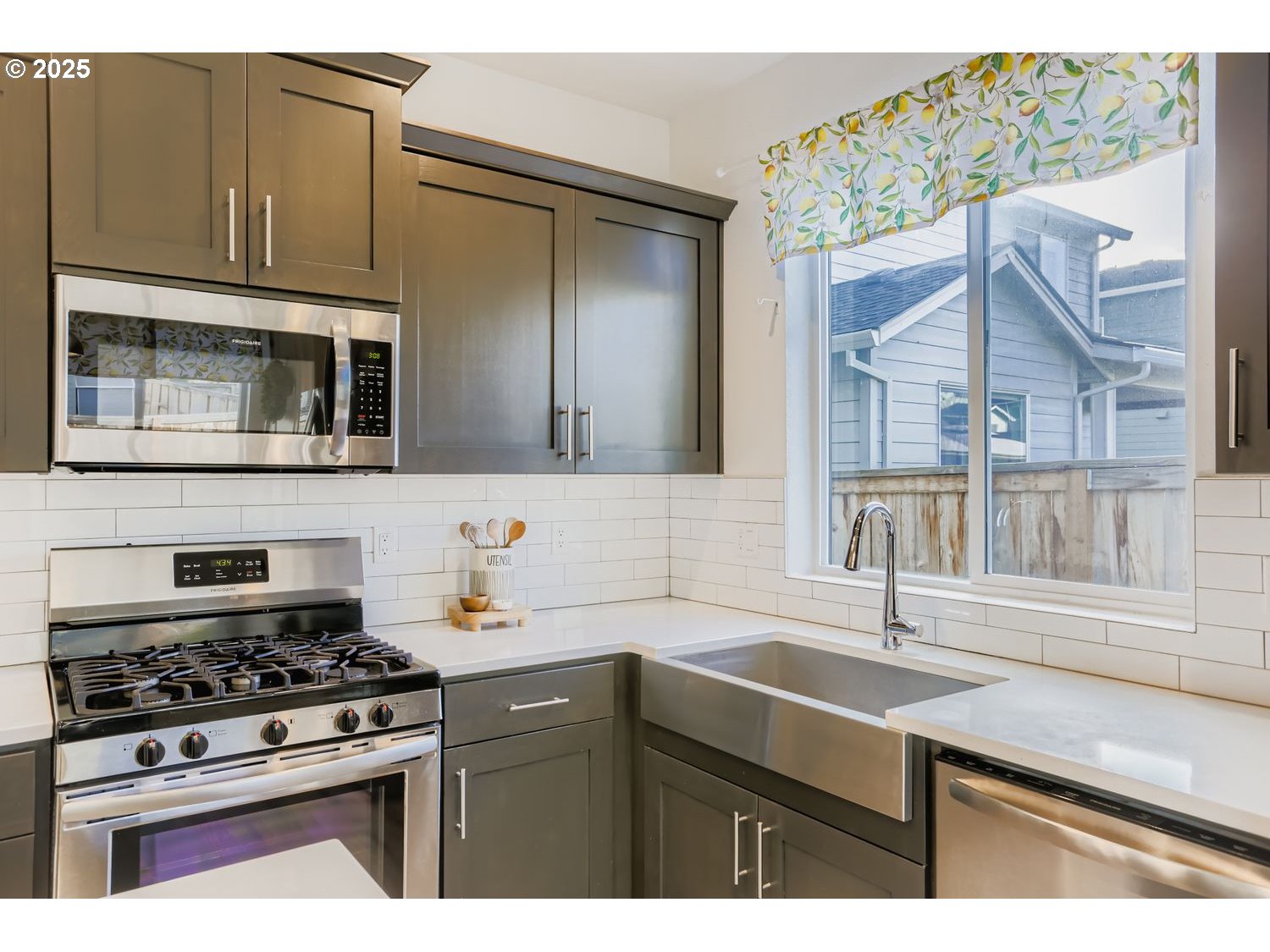234 West 18th Street Lafayette, OR 97127 - Photo 13 of 27 a kitchen with stainless steel appliances a stove a sink and a microwave