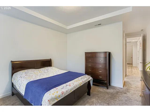 a bedroom with a bed and a dresser