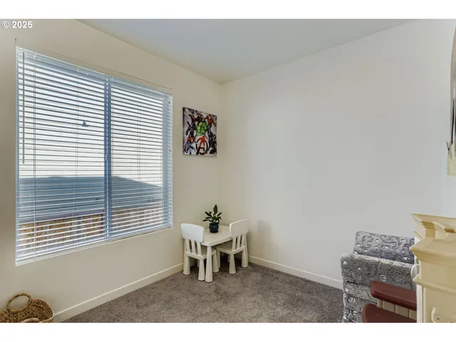 a dining room with furniture and a window