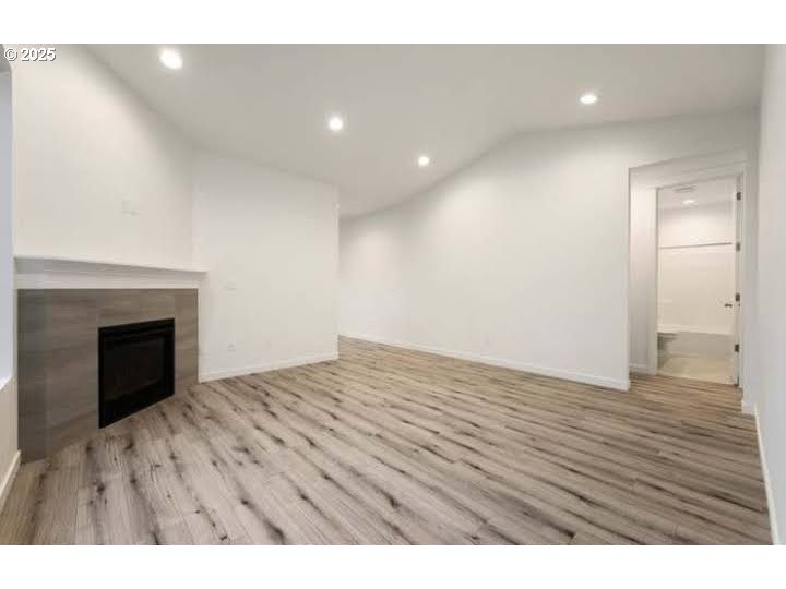 234 West 18th Street Lafayette, OR 97127 - Photo 3 of 27 a view of an empty room with wooden floor and a fireplace