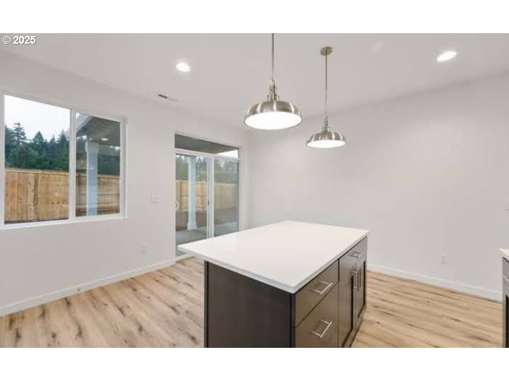 234 West 18th Street Lafayette, OR 97127 - Photo 6 of 27 a kitchen with a wooden floor and a chandelier