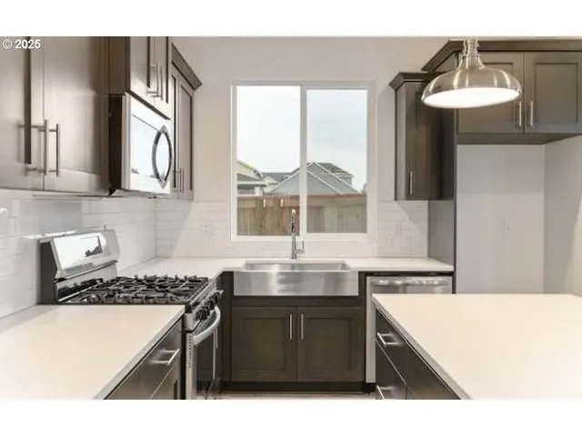 a kitchen with a sink and a stove