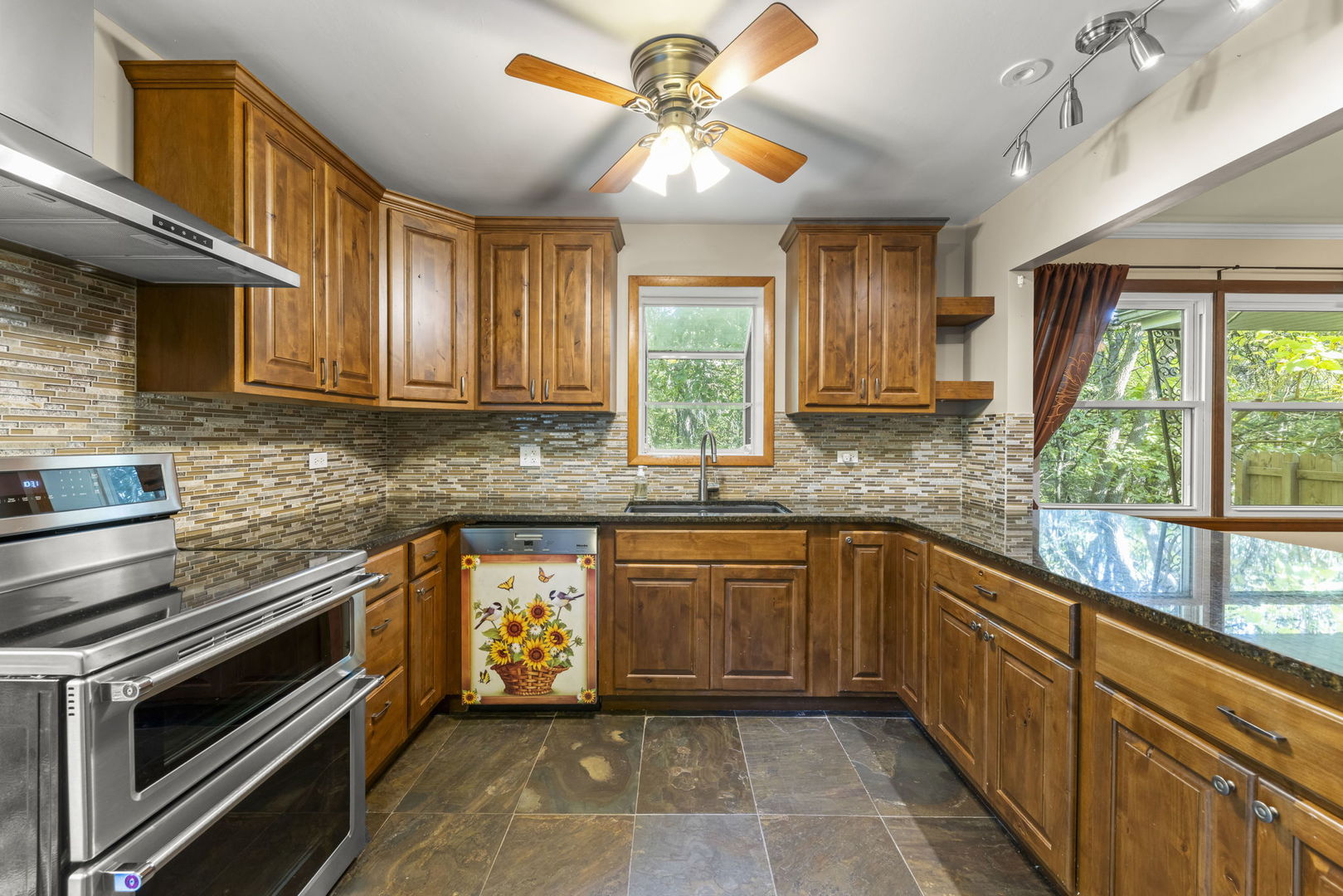 18000 Armitage Court Homewood, IL 60430 - Photo 9 of 23 a kitchen with stainless steel appliances granite countertop a stove sink and cabinets