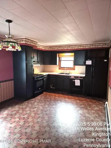 a kitchen with kitchen island a sink stainless steel appliances and a counter top