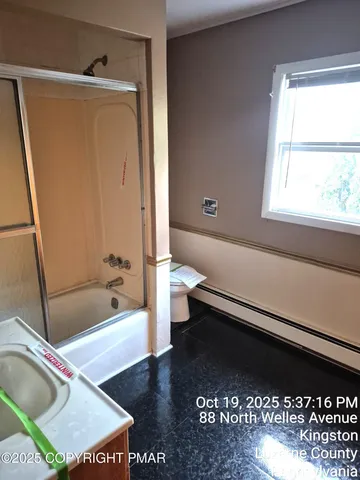 a bathroom with a bathtub a toilet and a shower