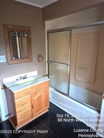 a bathroom with a sink a mirror and a shower