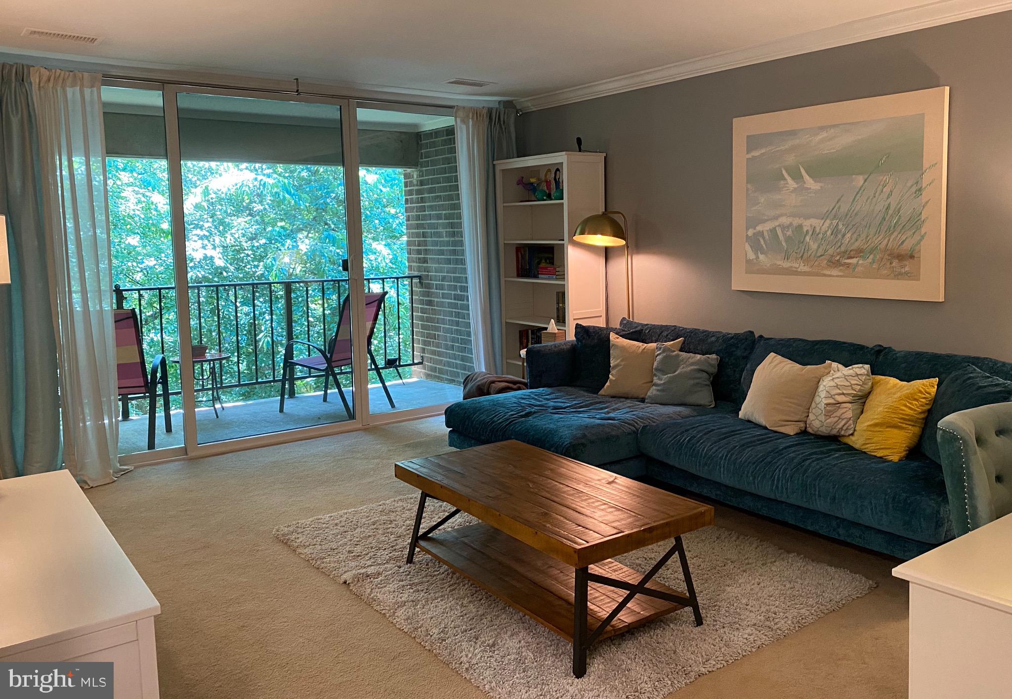 1411 Northgate Square, Unit 22B Reston, VA 20190 - Photo 4 of 17 Living room with large slider and private balcony