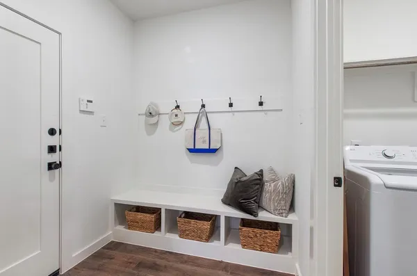 a view of a livingroom with wooden floor and furniture