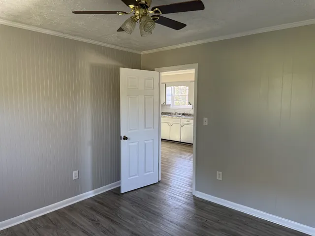 a view of an empty room and wooden floor