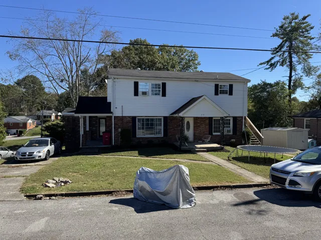 a view of a house with sitting area and a small yard