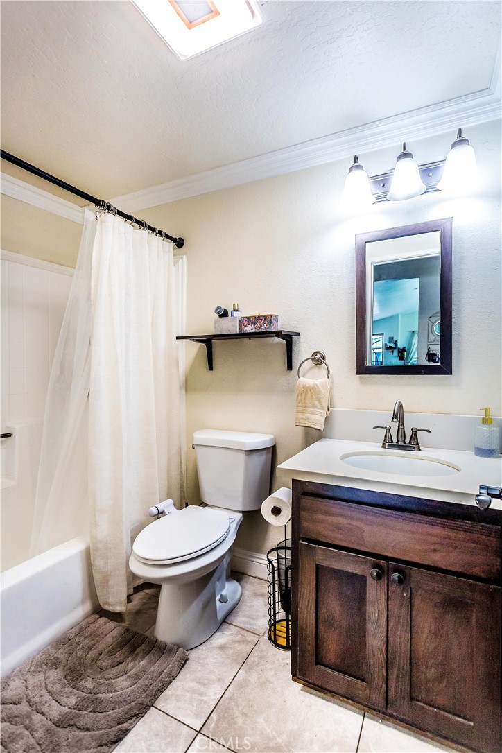3050 West Ball Road, Unit 200 Anaheim, CA 92804 - Photo 11 of 21 a bathroom with a sink toilet and mirror