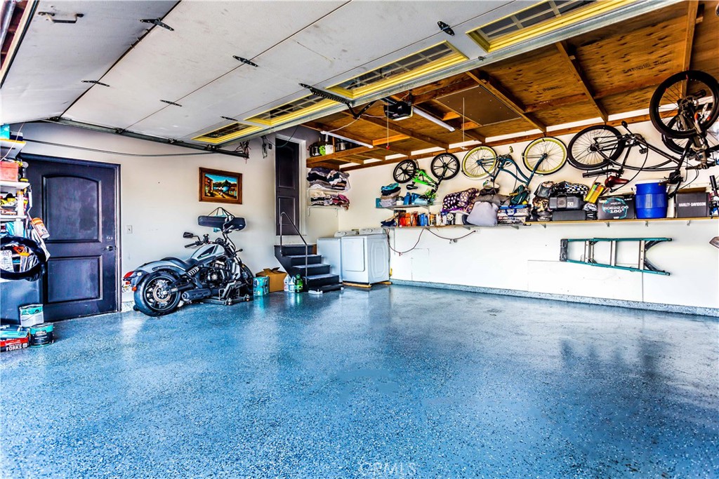 3050 West Ball Road, Unit 200 Anaheim, CA 92804 - Photo 18 of 21 a view of a garage with a bike and wooden roof