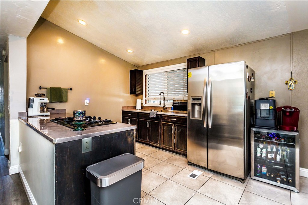 3050 West Ball Road, Unit 200 Anaheim, CA 92804 - Photo 7 of 21 a kitchen with stainless steel appliances granite countertop a refrigerator a stove a sink and a refrigerator