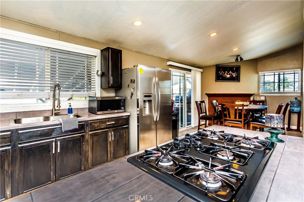 3050 West Ball Road, Unit 200 Anaheim, CA 92804 - Photo 8 of 21 a kitchen with lots of counter top space and stainless steel appliances